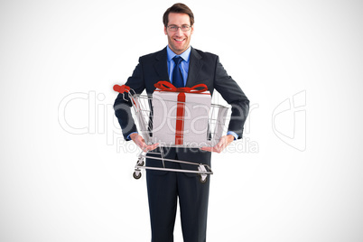 Composite image of businessman holding something with his hands