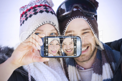 Composite image of hand holding smartphone showing