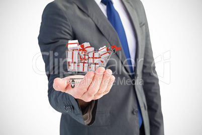 Composite image of businessman holding out his hand