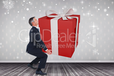 Composite image of stylish man with giant gift