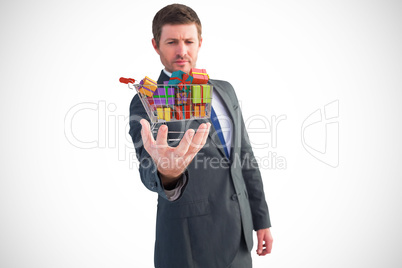 Composite image of businessman holding out his hand