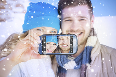 Composite image of hand holding smartphone showing