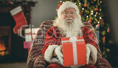 Santa claus offering a red gift