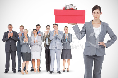 Composite image of smiling businesswoman holding tablet pc