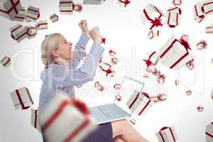 Composite image of businesswoman using laptop