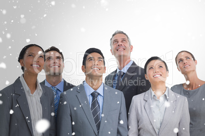 Composite image of business people looking up in office