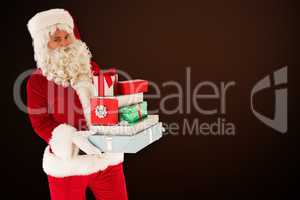 Composite image of father christmas holding many gifts