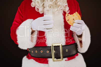 Composite image of santa having milk and cookie