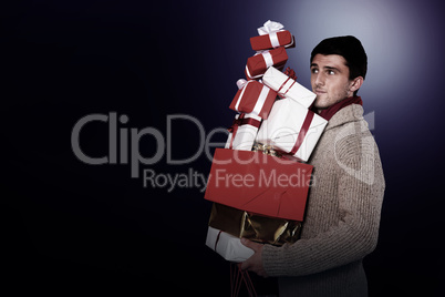 Young man with many christmas presents