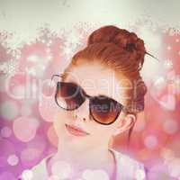 Composite image of hipster redhead wearing large sunglasses