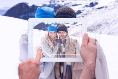 Composite image of hand holding tablet pc