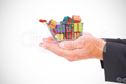 Composite image of businessman holding his hands out