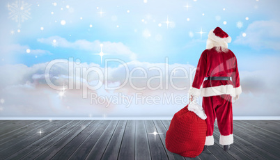 Composite image of santa with sack of gifts