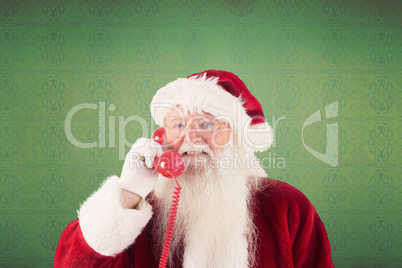 Composite image of santa claus on the phone