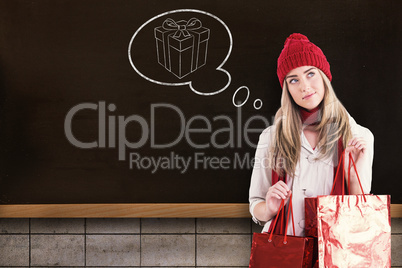 Composite image of pretty blonde holding shopping bags