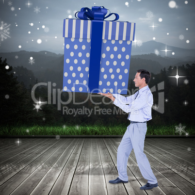 Composite image of stylish man with giant gift