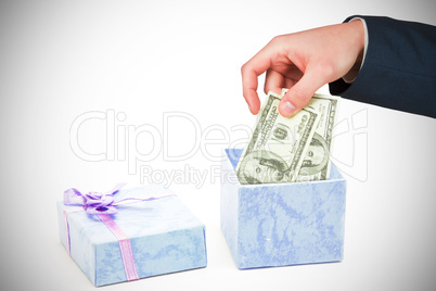 Composite image of hand holding hundred dollar bills