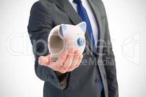 Composite image of businessman holding out his hand