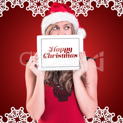 Composite image of festive blonde showing a tablet