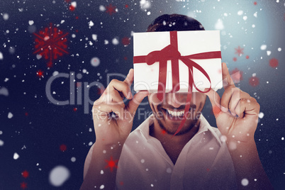 Composite image of man holding gift