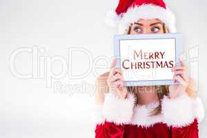 Composite image of pretty santa girl holding tablet