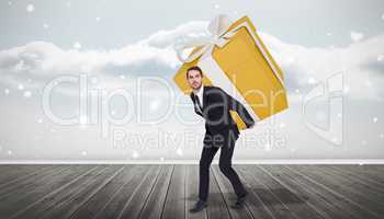 Composite image of stylish man with giant gift