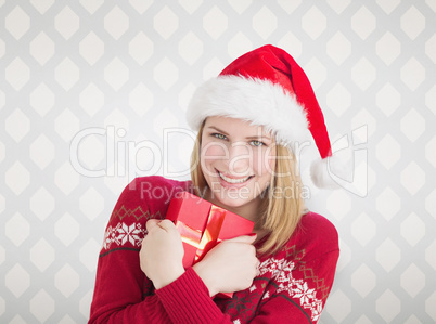 Composite image of woman holding christmas present