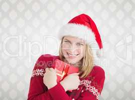 Composite image of woman holding christmas present