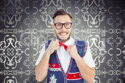 Composite image of geeky hipster wearing christmas vest