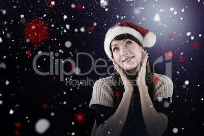 Composite image of smiling woman wearing santa hat