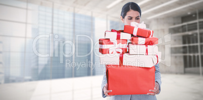 Composite image of fired businesswoman holding box of belongings
