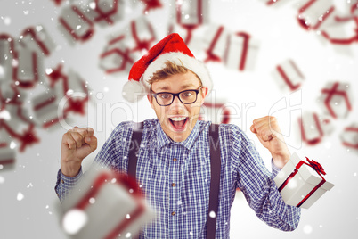 Composite image of geeky hipster wearing santa hat