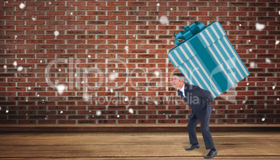 Composite image of stylish man with giant gift