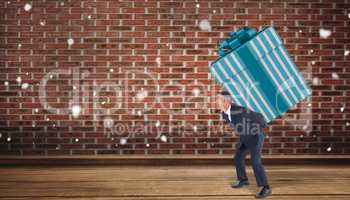 Composite image of stylish man with giant gift