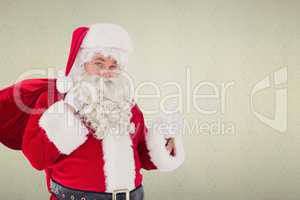Composite image of santa claus with his sack and thumbs up
