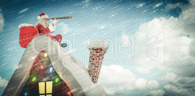 Composite image of santa sitting on roof of cottage