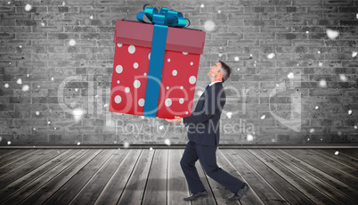 Composite image of stylish man with giant gift