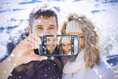 Composite image of hand holding smartphone showing