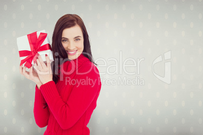 Composite image of smiling brunette in red jumper hat showing a