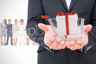 Composite image of businessman holding his hands out