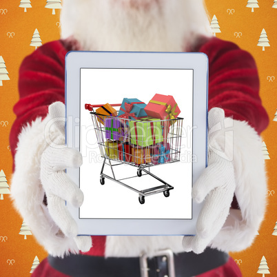 Composite image of santa presents a tablet pc