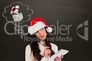 Composite image of festive brunette thinking about her christmas