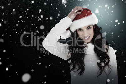 Composite image of confused brunette in santa hat