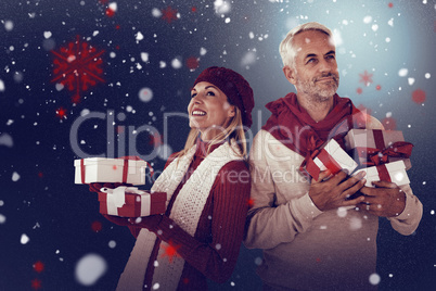 Composite image of happy festive couple with gifts