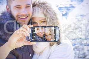 Composite image of hand holding smartphone showing