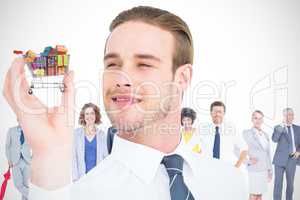 Composite image of happy businessman holding his hand up