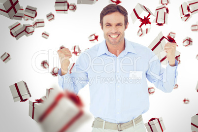 Composite image of happy businessman celebrating victory