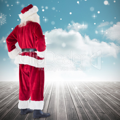 Composite image of santa with hands on hips