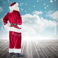 Composite image of santa with hands on hips
