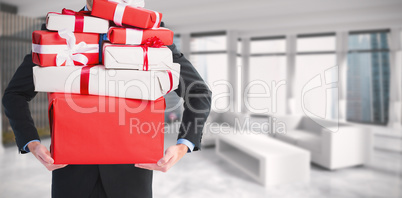 Composite image of businessman holding something with his hands